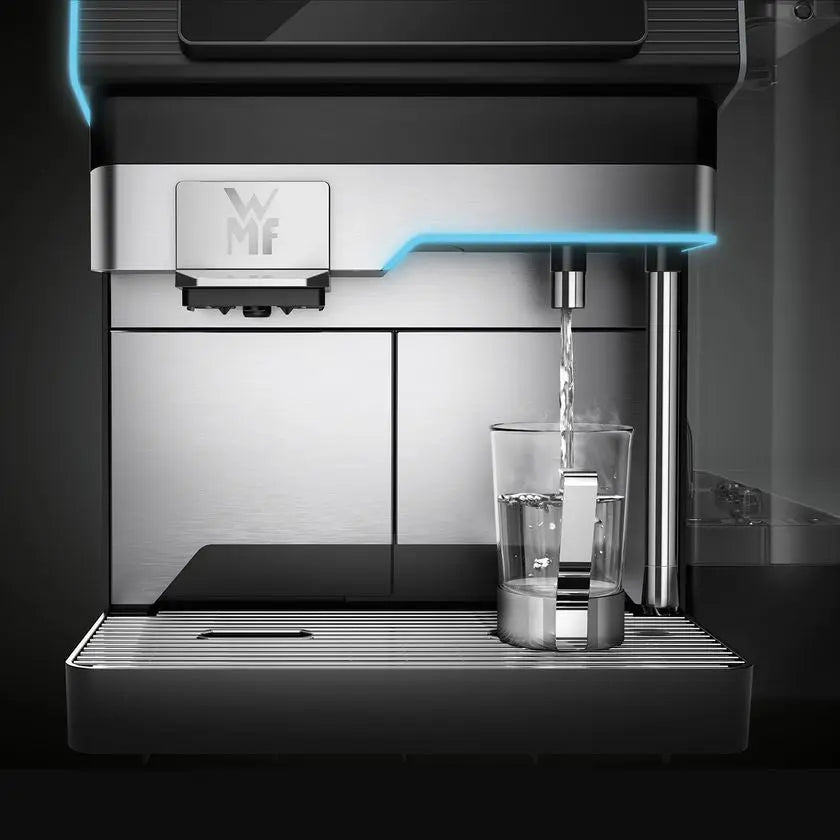 WMF Elavation 10 coffee machine dispensing water into a glass on a dark background - Sip N Smile
