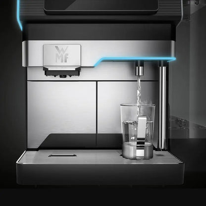 WMF Elavation 10 coffee machine dispensing water into a glass on a dark background - Sip N Smile
