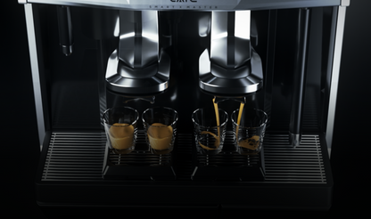 Caye X Master Coffee machine with multiple cups being filled with coffee on a black background