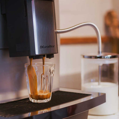 Coffee being poured from a machine into a glass, with 'Di.Coffee' branding.