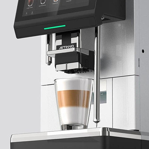 JL38 Modern coffee machine dispensing a glass of coffee with a blurred kitchen background