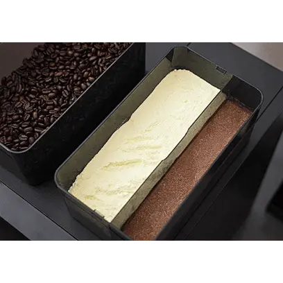 JL32 Two loaf pans filled with different types of bread on a black surface, next to a container of coffee beans. - Sip N Smile
