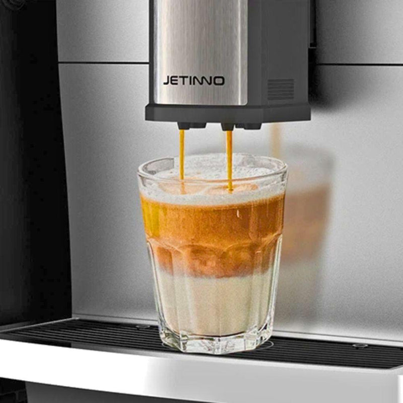 JL 30 Espresso being poured into a glass from a Jetinno coffee machine.